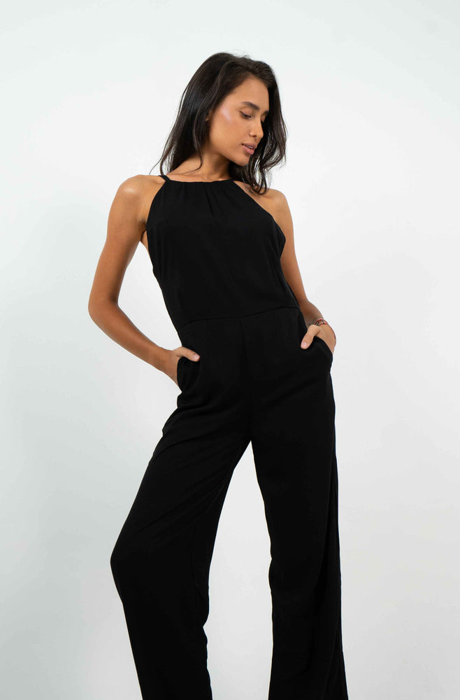 Black backless jumpsuit with two front pockets. Fluid and comfortable material.