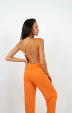 Orange backless jumpsuit. Gathered elastic waistband and back zipper.
