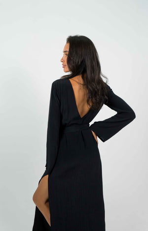 
            
                Load image into Gallery viewer, Long black dress with a large bare V-shaped back. With long sleeves. It is split on the left side.
            
        