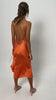 video of woman wearing a lovely backless dress by Back Cartel in orange. Back cartel, the brand specialised in backless outfits.