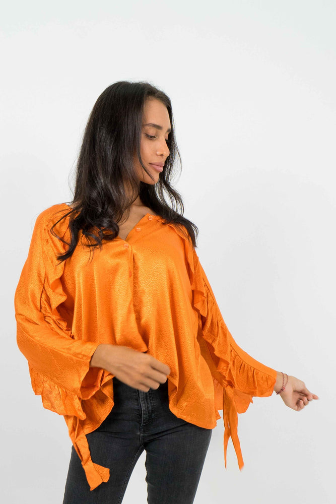Orange backless shirt, with ruffled sleeves. Textured satin material.