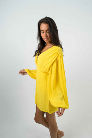 
            
                Charger l&amp;#39;image dans la galerie, A backless yellow mini dress with long balloon sleeves. Zipper at the back. And buttons on the front neckline.
            
        