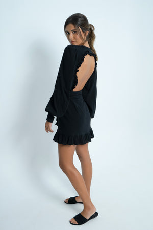 Black backless mini dress in 100% cotton. With puff sleeves. Closes wraparound with a wide belt.