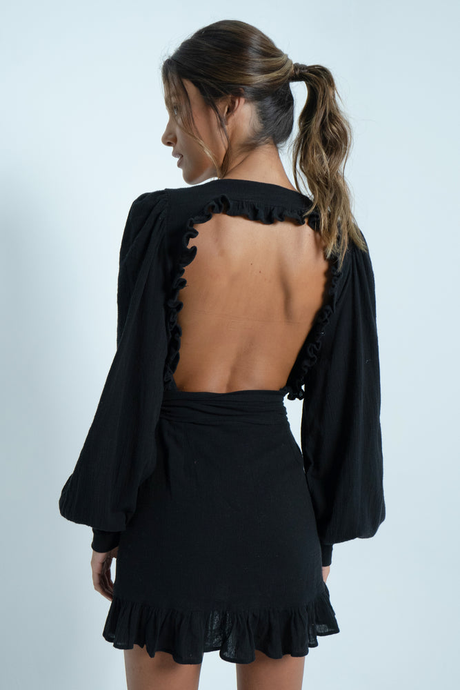 Beautiful square bare back on a 100% cotton black mini dress. It has puffy sleeves and closes like a crossover with a wide belt.