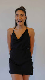 Black backless mini dress, thin adjustable straps. Fluid and delicate material.