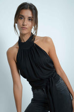 Black backless top. Closes at the neck.