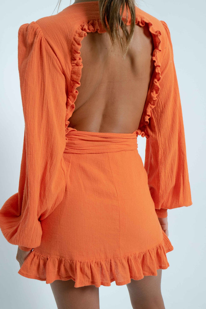 Beautiful square bare back on a 100% cotton orange mini dress. It has puffy sleeves and closes like a crossover with a wide belt.