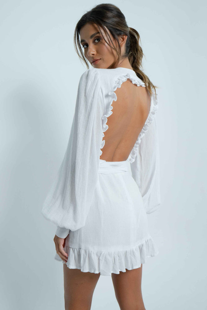 Beautiful square bare back on a 100% cotton white mini dress. It has puffy sleeves and closes like a crossover with a wide belt.