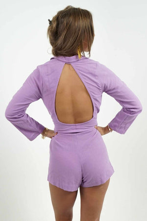 Beautiful bare back on a purple linen jumpsuit. It has a blazer style neckline and a fitted belt at the waist.