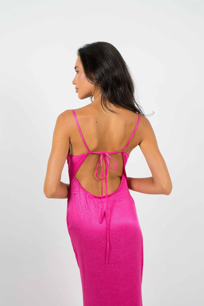 Long open back dress in pink and 100% viscose. Adjustable at the back to your liking. By Back Cartel.