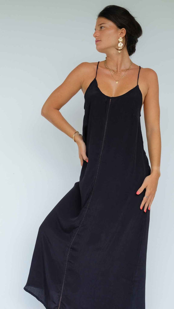 Black backless long dress. Adjustable laces that can cross in the back. Fine embroidery on the front.