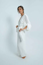 Long puff sleeve and long length white dress by Back Cartel, the French brand for backless lovers. The Kimi white long dress is perfect for a chill summer night.